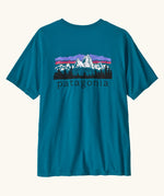 Patagonia men's fitz roy foothills short sleeve t-shirt in glacier blue showing a large mountain branded print on the upper back. 