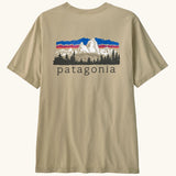 Patagonia men's fitz roy foothills short sleeve t-shirt in beige showing a large mountain branded print on the upper back. 