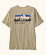 Patagonia men's fitz roy foothills short sleeve t-shirt in beige showing a large mountain branded print on the upper back. 