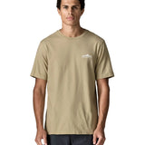 Man wearing Patagonia's  fitz roy foothills short sleeve t-shirt in beige showing a small mountain branded print on the upper chest. Top has a relaxed fit