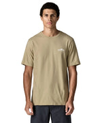 Man wearing Patagonia's  fitz roy foothills short sleeve t-shirt in beige showing a small mountain branded print on the upper chest. Top has a relaxed fit