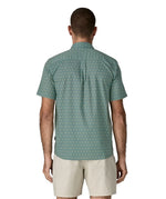 Back of man wearing Patagonia men's buttoned short sleeve shirt in sage blue. Shirt has relaxed fit and sits at the hips