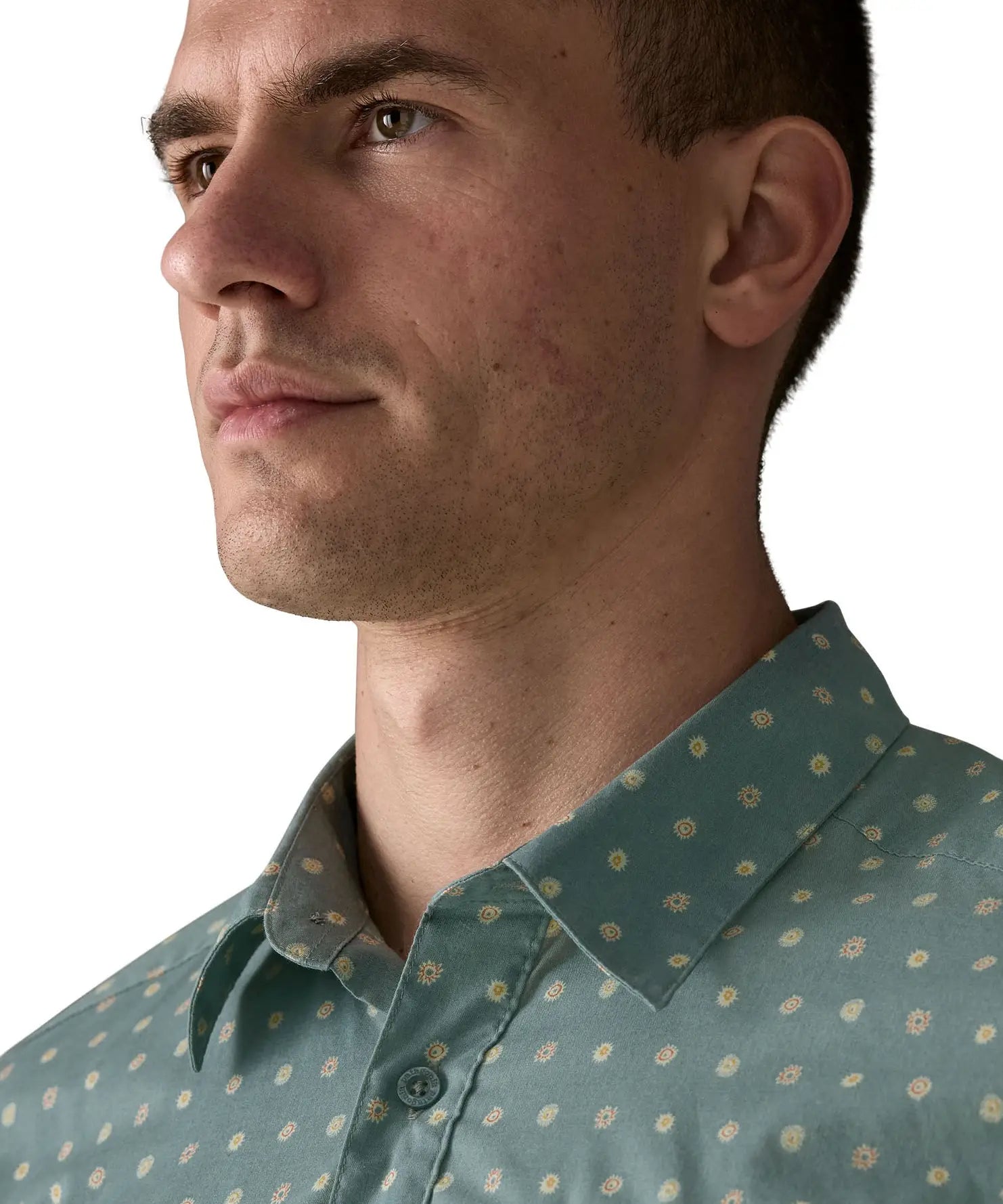 Collar of Patagonia men's buttoned short sleeve shirt in sage blue with repeating mini sun pattern design 