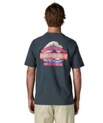 Man wearing Patagonia men's great waves responsibili short sleeve shirt in dark blue with large wave graphic on upper back