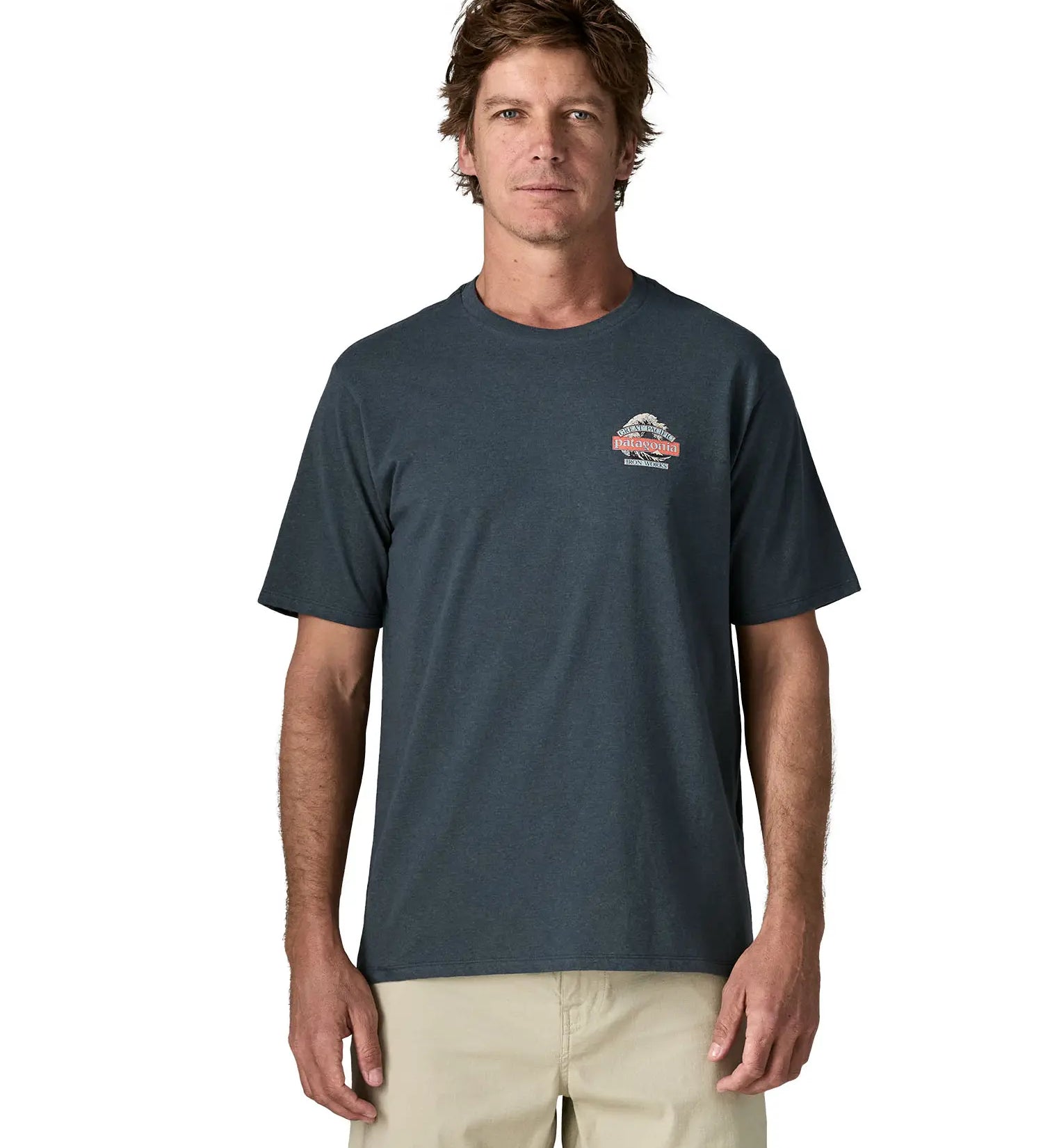 Man wearing Patagonia men's great waves responsibili short sleeve shirt in dark blue with small wave graphic on chest