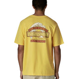 Man wearing Patagonia men's great waves responsibili short sleeve shirt in yellow with large wave graphic on upper back