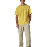 Man wearing Patagonia men's great waves responsibili short sleeve shirt in yellow. T-shirt has a relaxed fit and sits at the hips