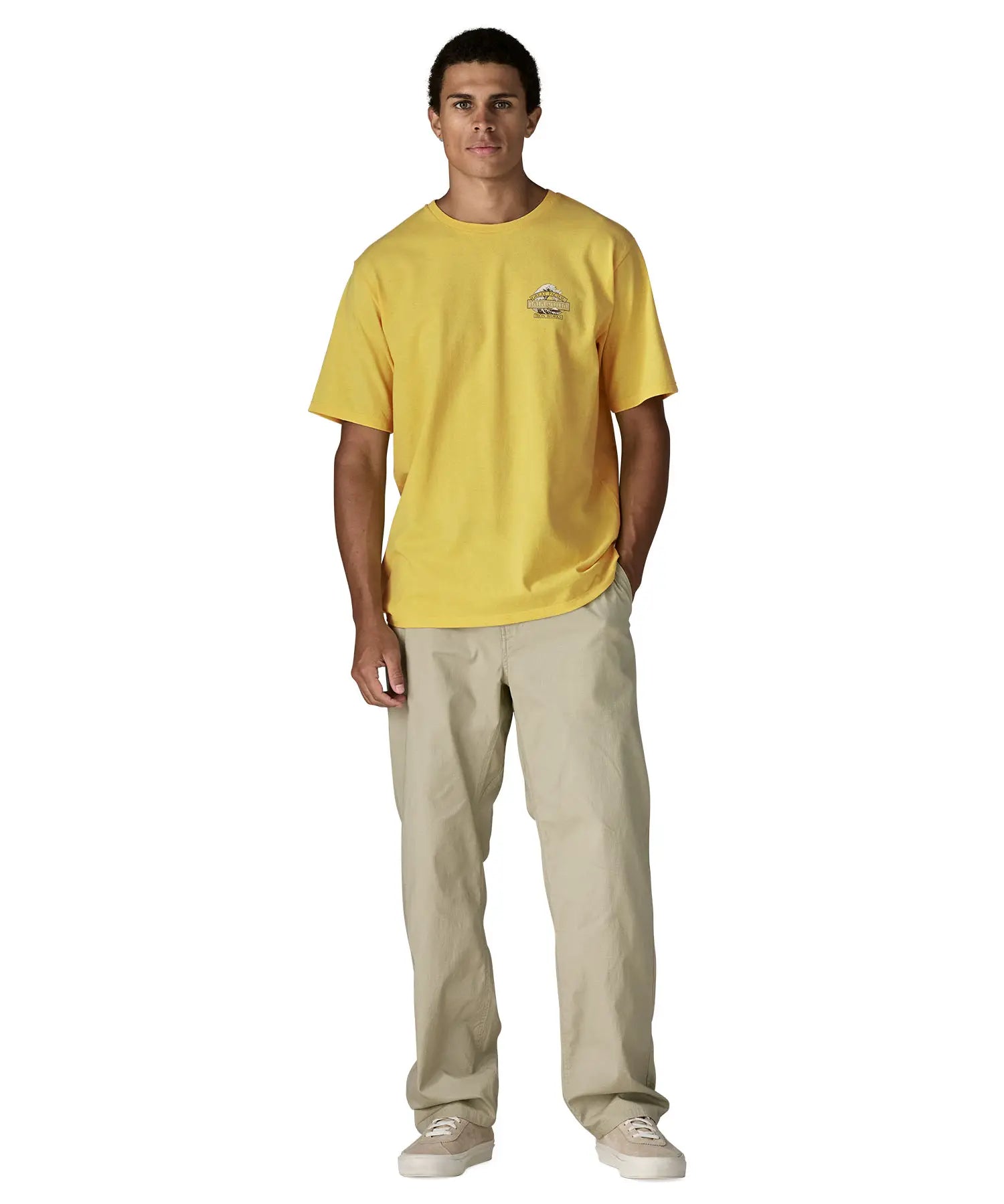 Man wearing Patagonia men's great waves responsibili short sleeve shirt in yellow. T-shirt has a relaxed fit and sits at the hips