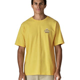 Man wearing Patagonia men's great waves responsibili short sleeve shirt in yellow with small wave graphic on chest