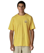 Man wearing Patagonia men's great waves responsibili short sleeve shirt in yellow with small wave graphic on chest
