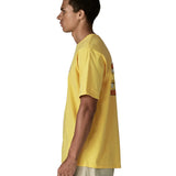 Side of man wearing Patagonia men's great waves responsibili short sleeve shirt in yellow. T-shirt has a relaxed fit and sits at the hips