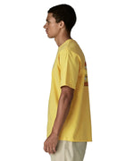 Side of man wearing Patagonia men's great waves responsibili short sleeve shirt in yellow. T-shirt has a relaxed fit and sits at the hips