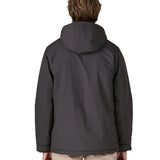 Back of man wearing Patagonia water repellent Isthmus parka in ink black with the hood down. Coat has a regular fit 