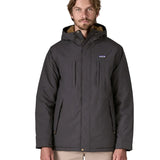 Man wearing Patagonia water repellent Isthmus parka in ink black showing full front zip and popper fastened and pockets