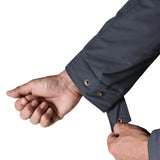 Man adjusting cuff size using the poppers on the Patagonia's isthmus parka jacket in dark blue 