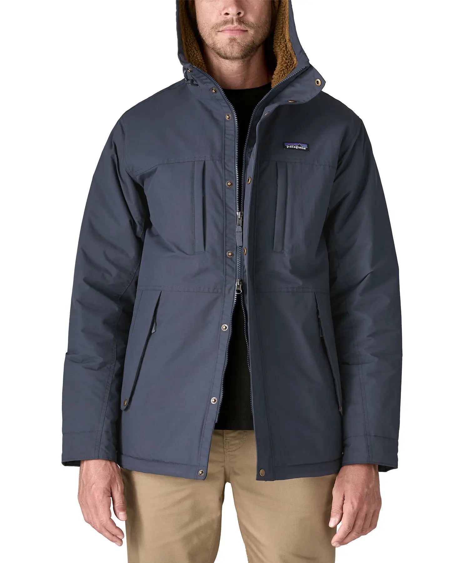 Man wearing Patagonia's isthmus parka jacket in dark blue showing the front double zips opening the jacket