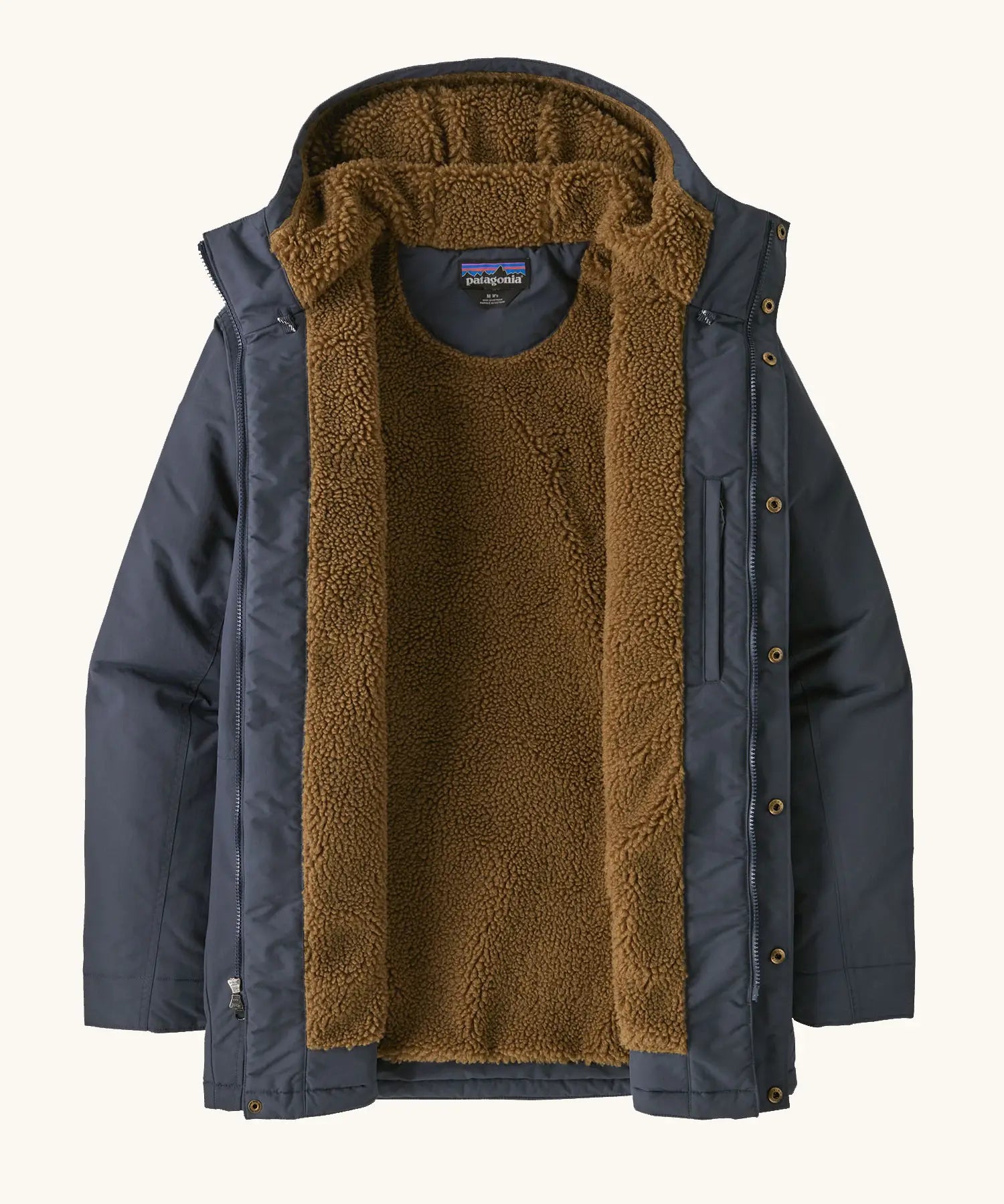 An open Patagonia men's isthmus parka jacket in dark blue showing the brown inner fleece