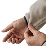Man wearing Patagonia's lightweight synchilla snap t fleece pullover in beige showing close up of navy trim on the cuff