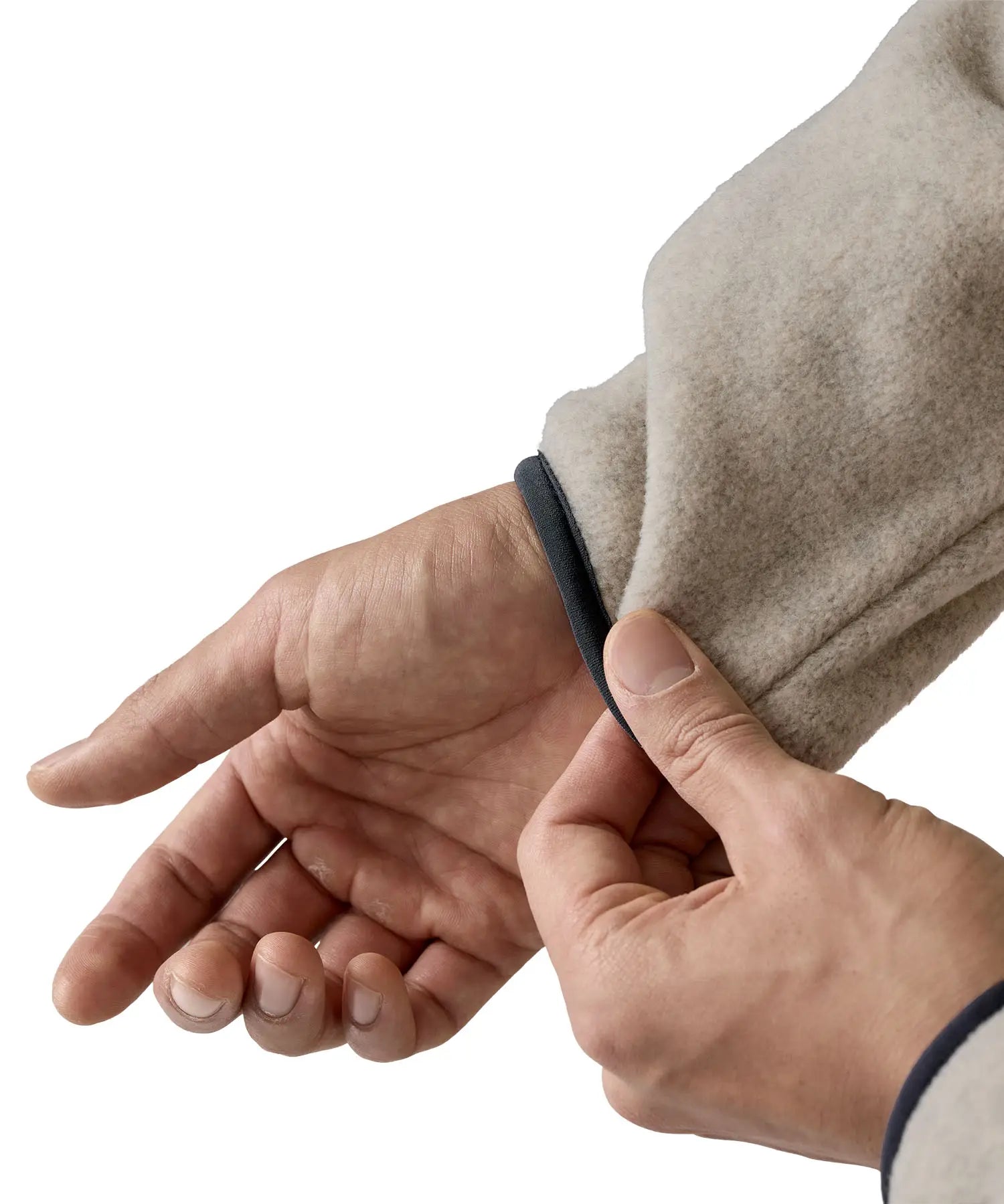 Man wearing Patagonia's lightweight synchilla snap t fleece pullover in beige showing close up of navy trim on the cuff