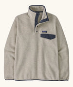 Patagonia mens lightweight synchilla snap t fleece pullover in beige with navy trim. Features 1/4 length popper fasteners and a chest pocket