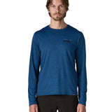 Man wearing Patagonia 73 skyline men's long sleeve capilene techincal t-shirt in blue. Top has a regular fit and sits around the hips