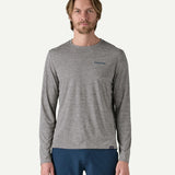 Front view of a man wearing the Patagonia Men’s Long Sleeved Capilene Cool Daily Graphic Shirt in Waters grey marl, with a small Patagonia logo on the left chest.
