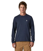 Man wearing Patagonia's hut tripper skyline long sleeve t-shirt in new navy showing a small P initial logo on the chest. Top has a relaxed fit