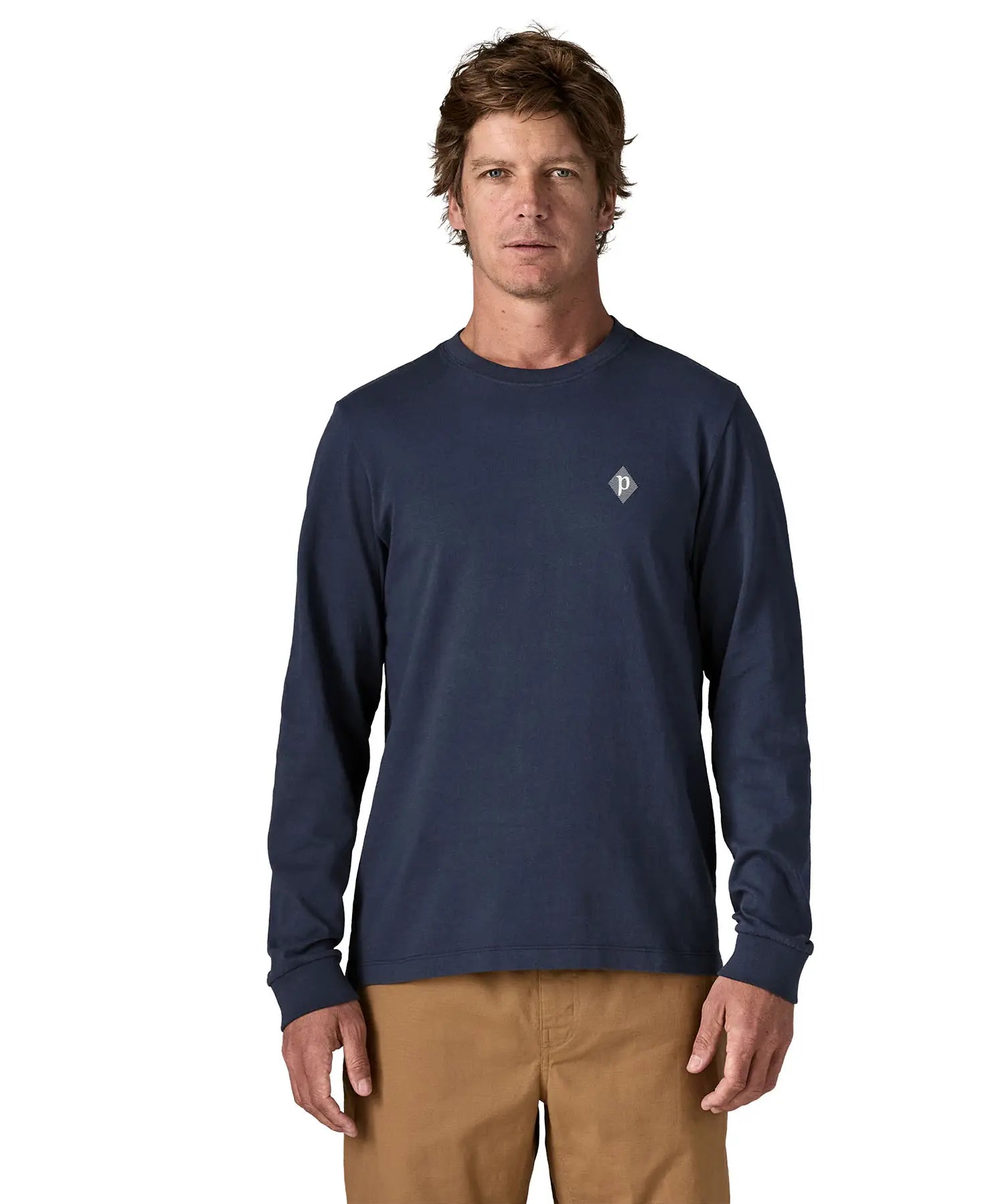 Man wearing Patagonia's hut tripper skyline long sleeve t-shirt in new navy showing a small P initial logo on the chest. Top has a relaxed fit