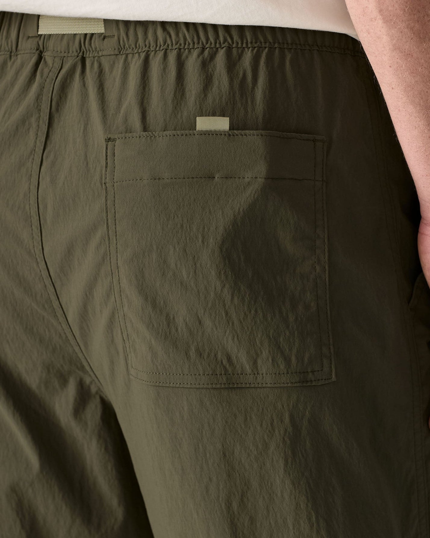 Close up of Patagonia's men's outdoor everyday quick drying shorts in green. Shows back pocket
