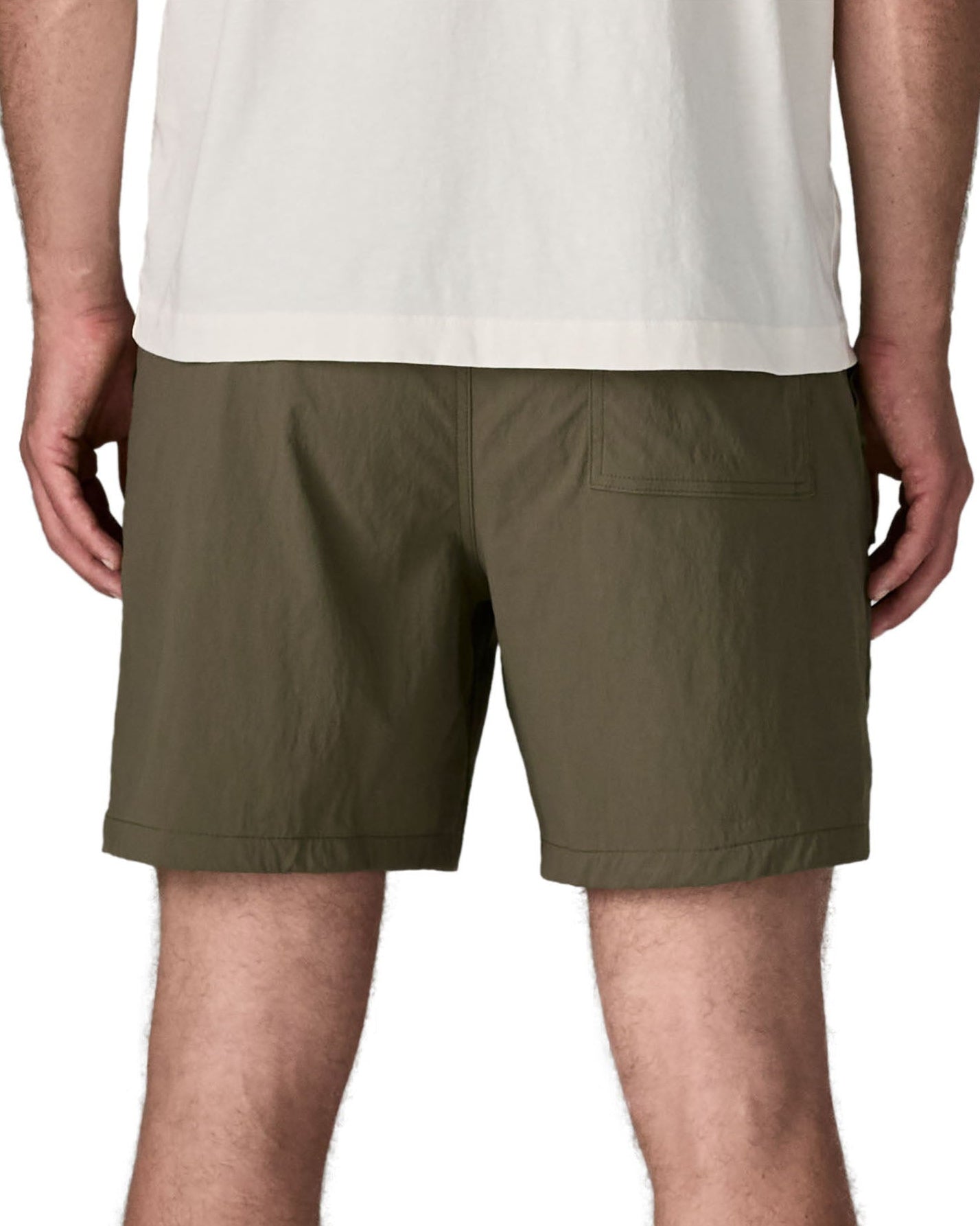 Back of man wearing Patagonia's men's outdoor everyday shorts in green. Shorts have a loose fit and sit above the knees