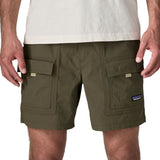Man wearing Patagonia's men's outdoor everyday shorts in green. Shows front pockets. Shorts have a loose fit