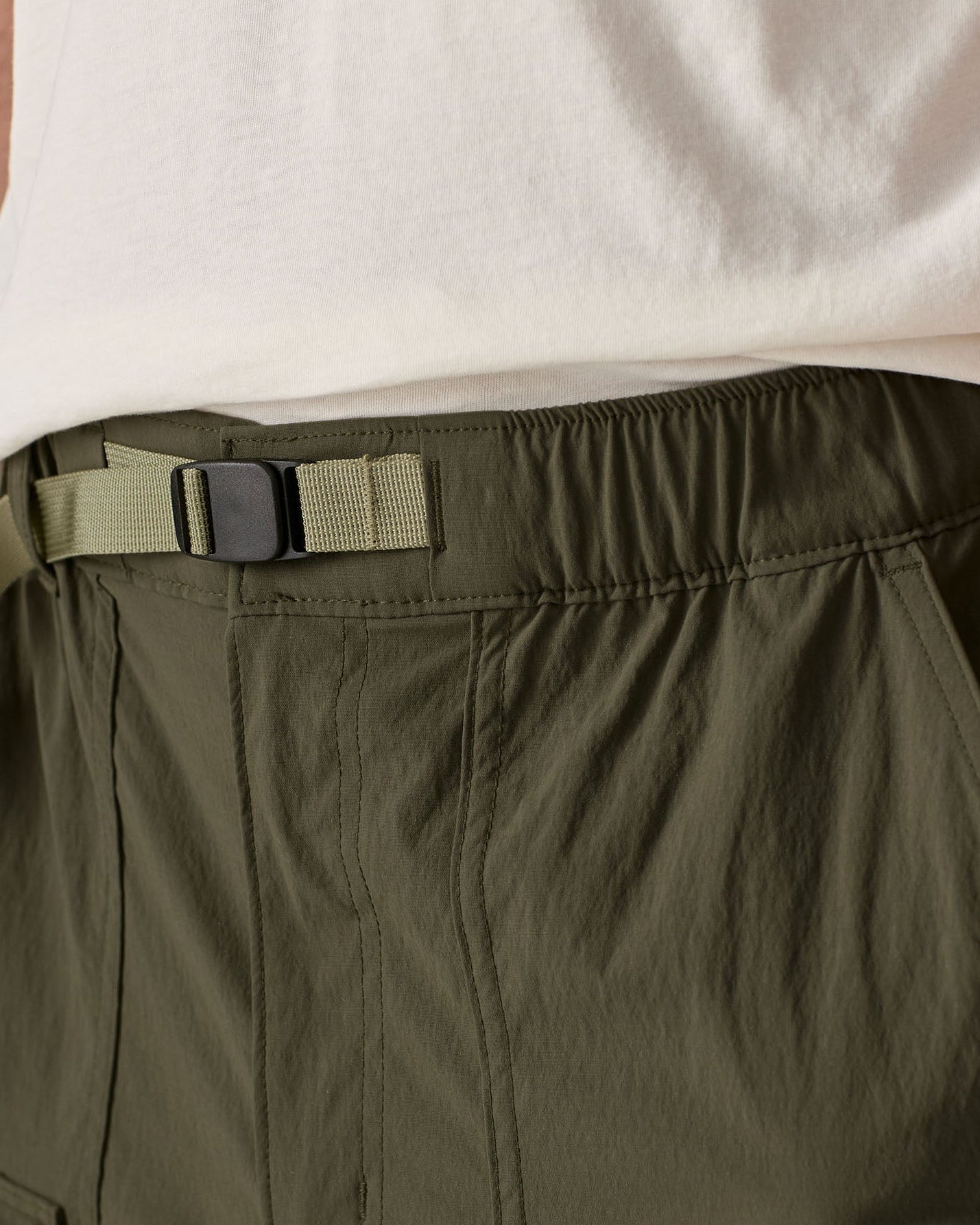 Close up of Patagonia men's outdoor everyday quick drying shorts in green showing light green belt.