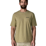 Man wearing Patagonia's men's responsibili t-shirt in green with brand text on chest. T-shirt has a relaxed fit