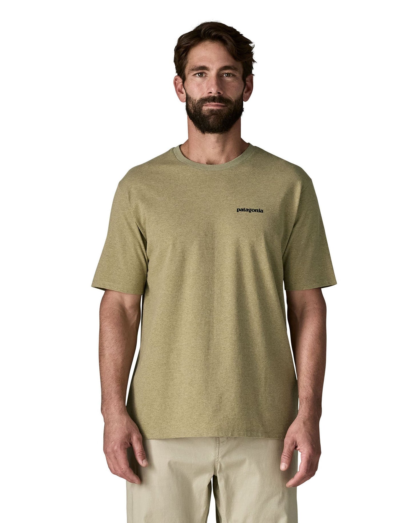 Man wearing Patagonia's men's responsibili t-shirt in green with brand text on chest. T-shirt has a relaxed fit