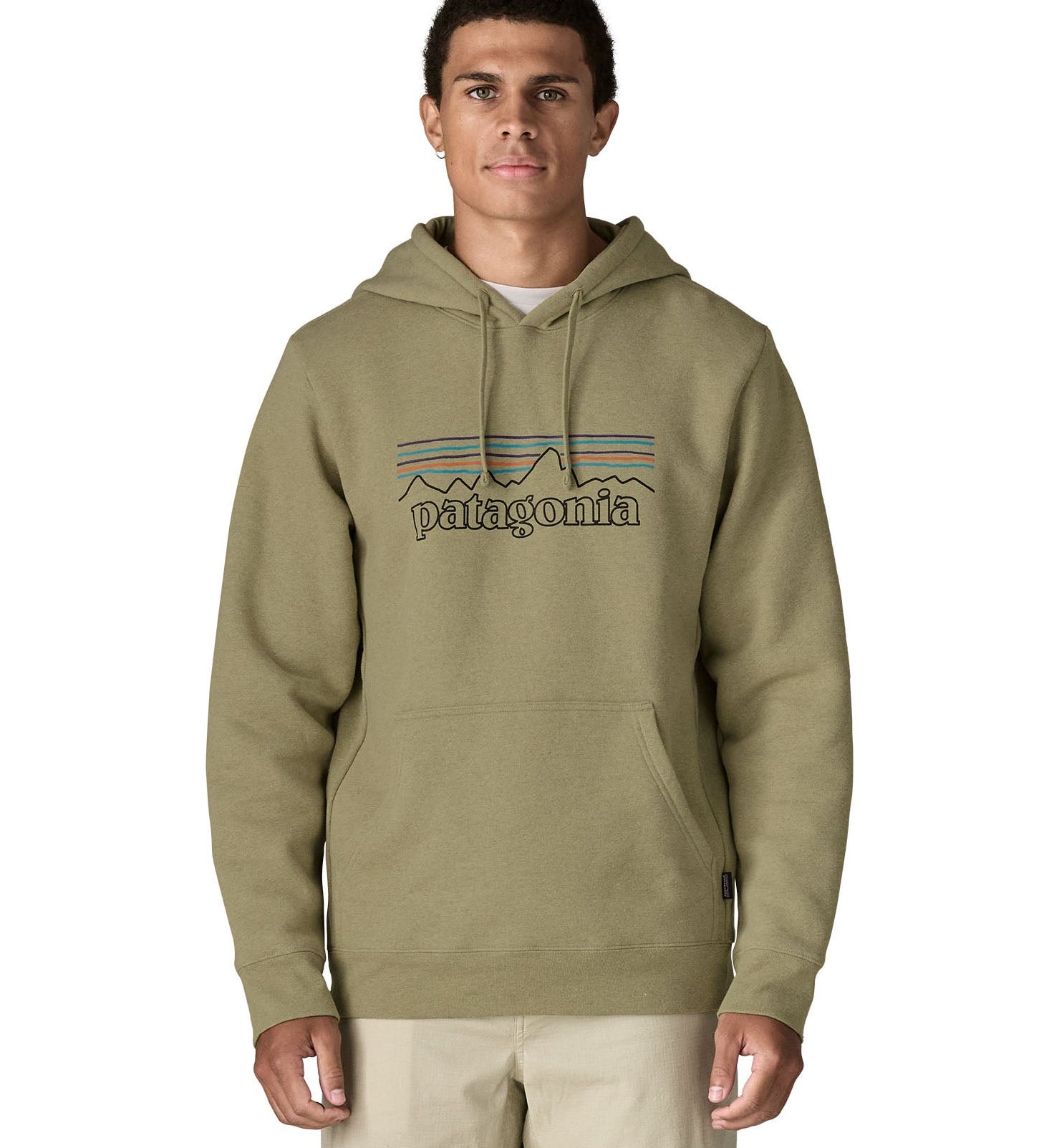 Front of man wearing Patagonia's P-6 Logo Uprisal Hoody in a pale green with the hood down. Hoody has a relaxed fit