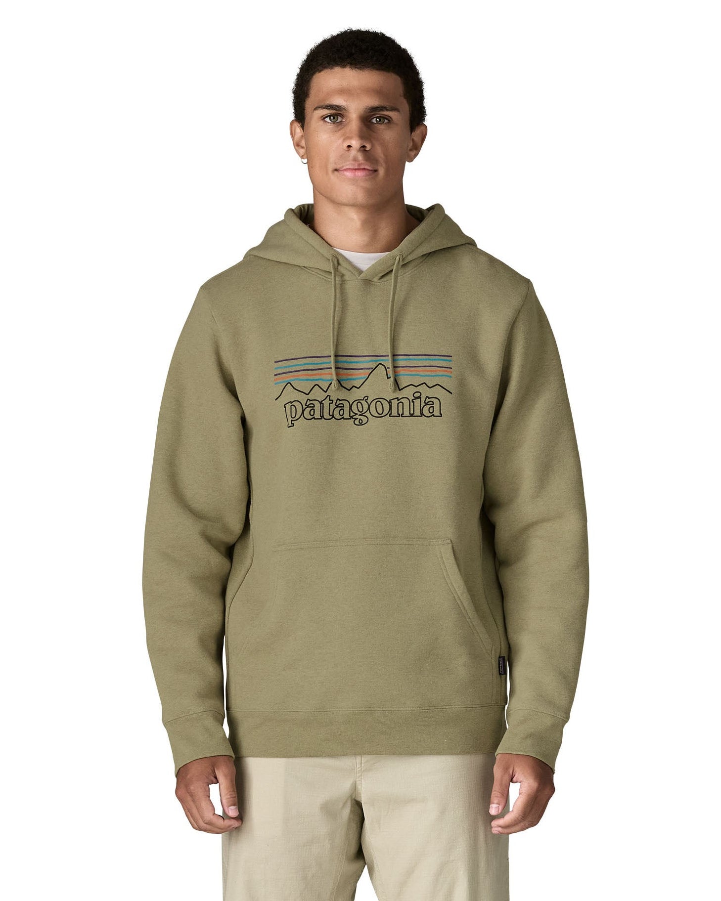 Front of man wearing Patagonia's P-6 Logo Uprisal Hoody in a pale green with the hood down. Hoody has a relaxed fit