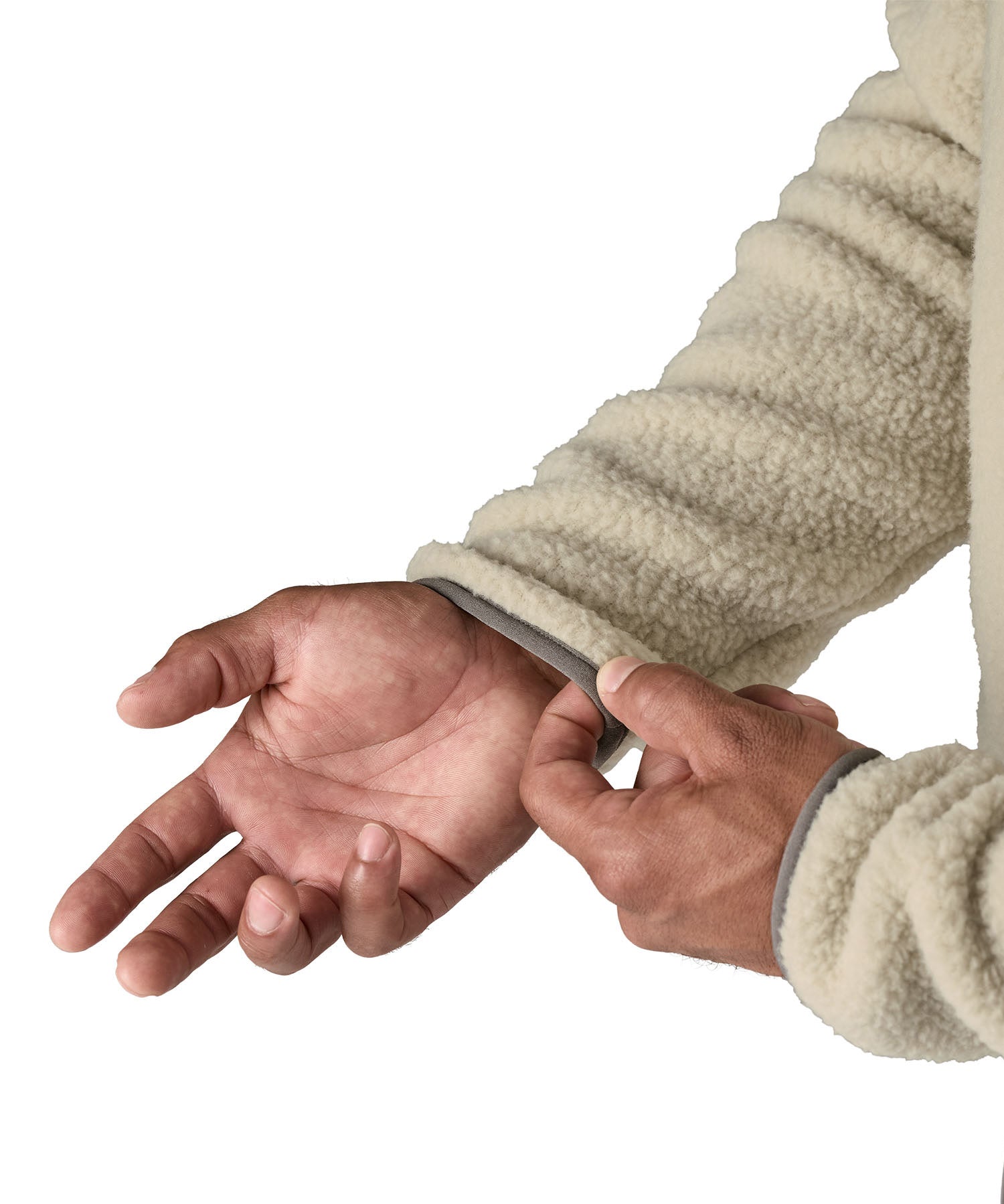 A close up of hand gently pulling the elastic cuff on the the Patagonia Men's Retro Pile Fleece Jacket in a Pelican colour available at Babipur.