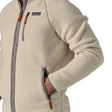 A close up of a man wearing the Patagonia Men's Retro Pile Fleece Jacket in a Pelican colour available at Babipur showing the full zip length and pocket detail