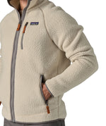 A close up of a man wearing the Patagonia Men's Retro Pile Fleece Jacket in a Pelican colour available at Babipur showing the full zip length and pocket detail