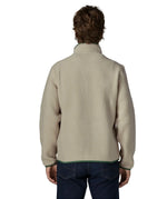 Back of man wearing a Patagonia retro pile jacket in beige with a green trim. Fleece has a relaxed fit