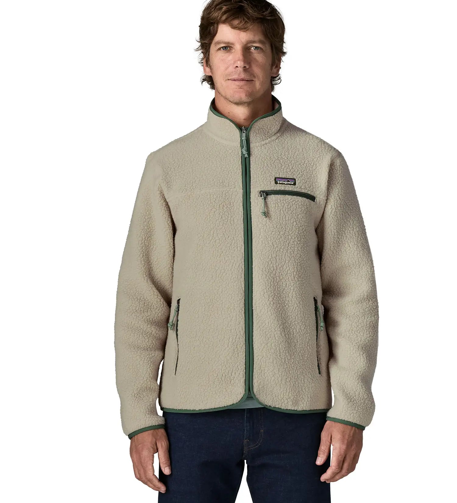 Front of man wearing a Patagonia retro pile jacket in beige with a green trim showing side and chest pockets. Features full front zip