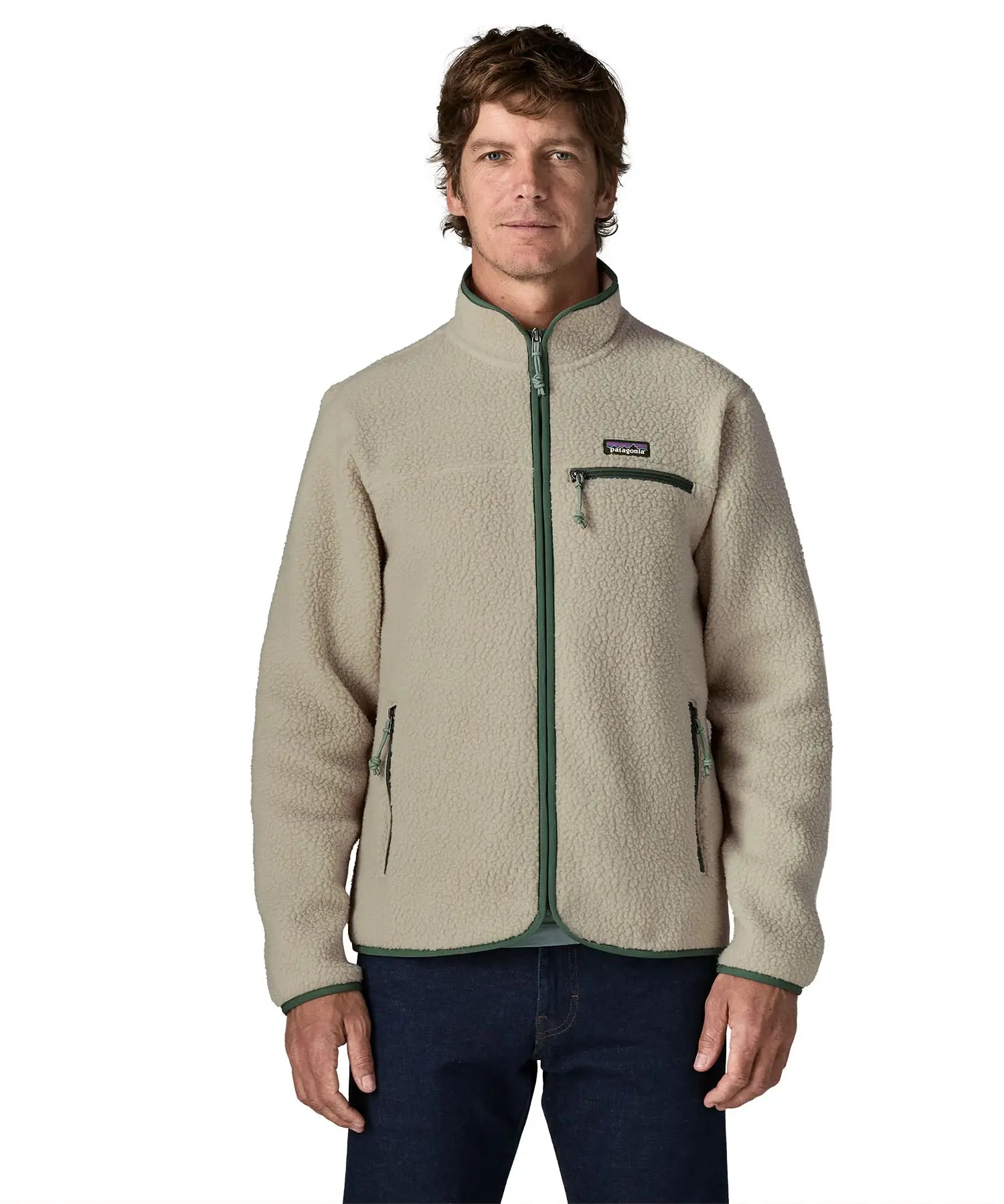 Front of man wearing a Patagonia retro pile jacket in beige with a green trim showing side and chest pockets. Features full front zip