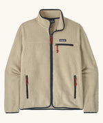 Patagonia men's retro pile fleece jacket in beige with navy trim. Features a full front zip, chest and side pockets
