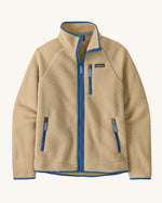 Patagonia Men's thick fleece jacket in a tan colour with blue trim. Features a full length front zip, side pockets and a zipped pocket.