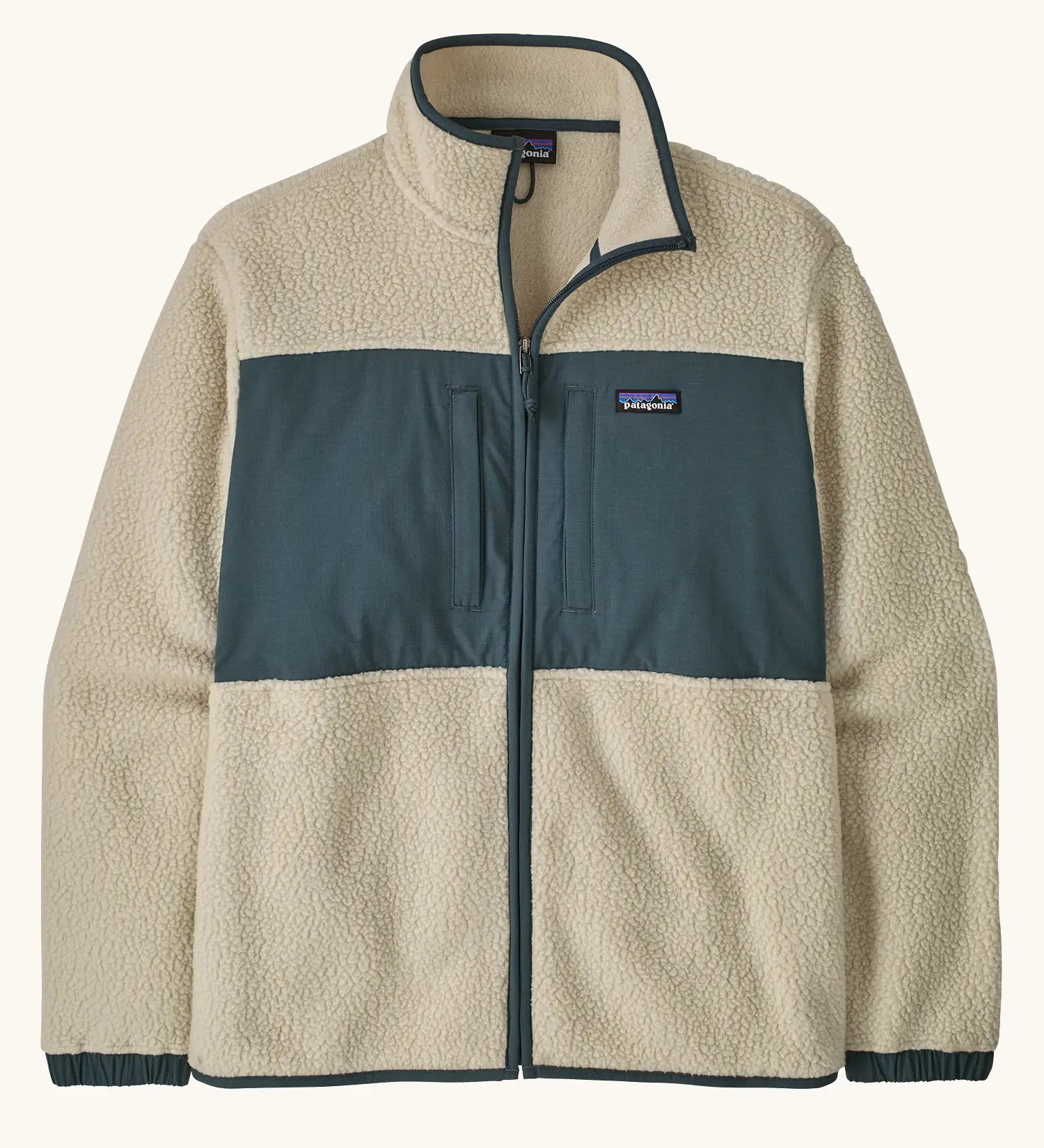 Patagonia men's retro pile patch jacket in beige with a navy trim and chest panel. Features chest pockets and elasticated cuffs