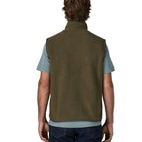 Back of man wearing Patagonia men's retro pile vest in dark green with a grey trim. Gilet has a relaxed fit