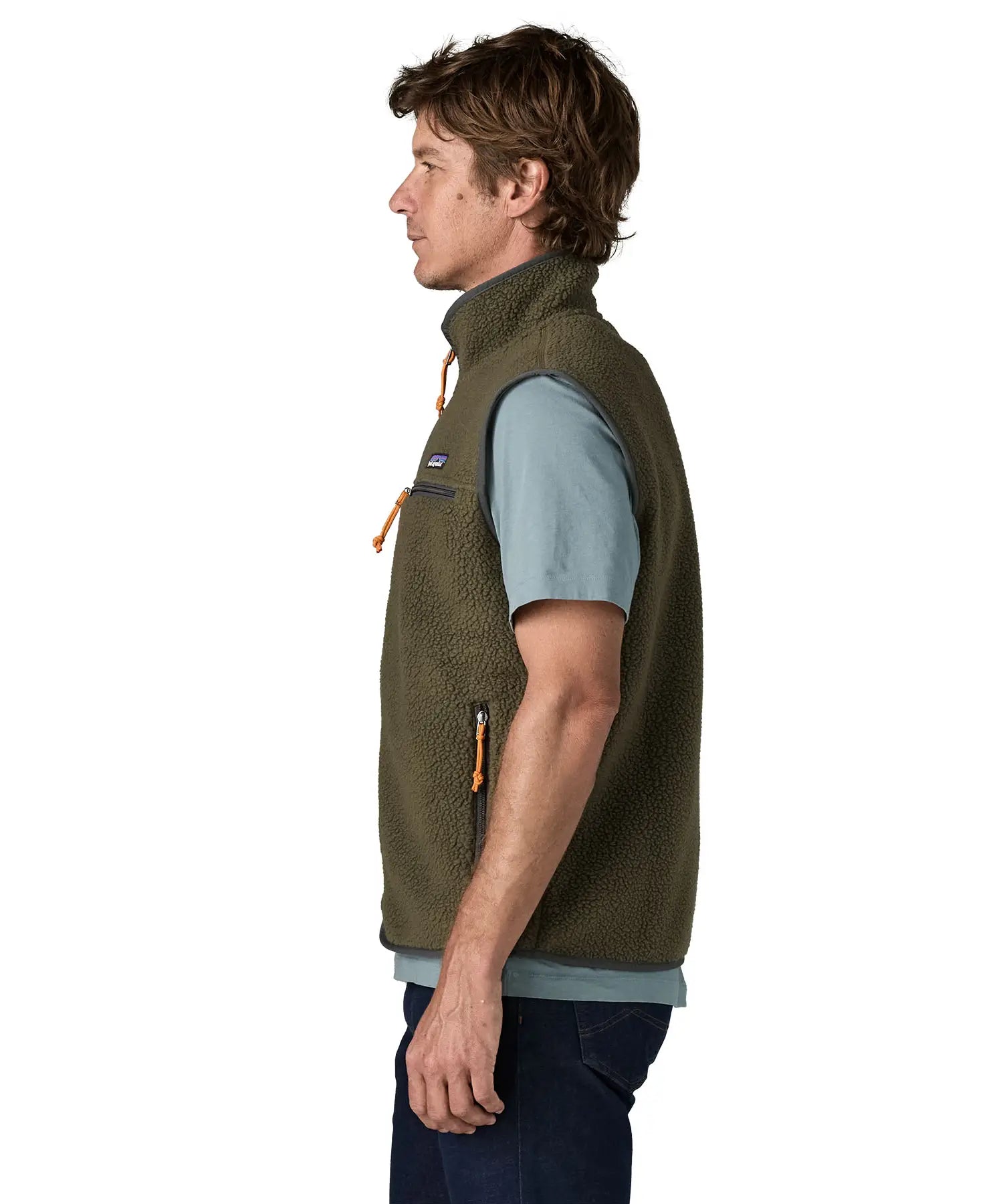 Side of man wearing Patagonia men's retro pile vest in dark green with a grey trim. Gilet features a turned up collar