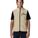 Man wearing Patagonia men's retro pile vest in beige with a navy trim. Showing front zip fastened. Gilet has a regular fit