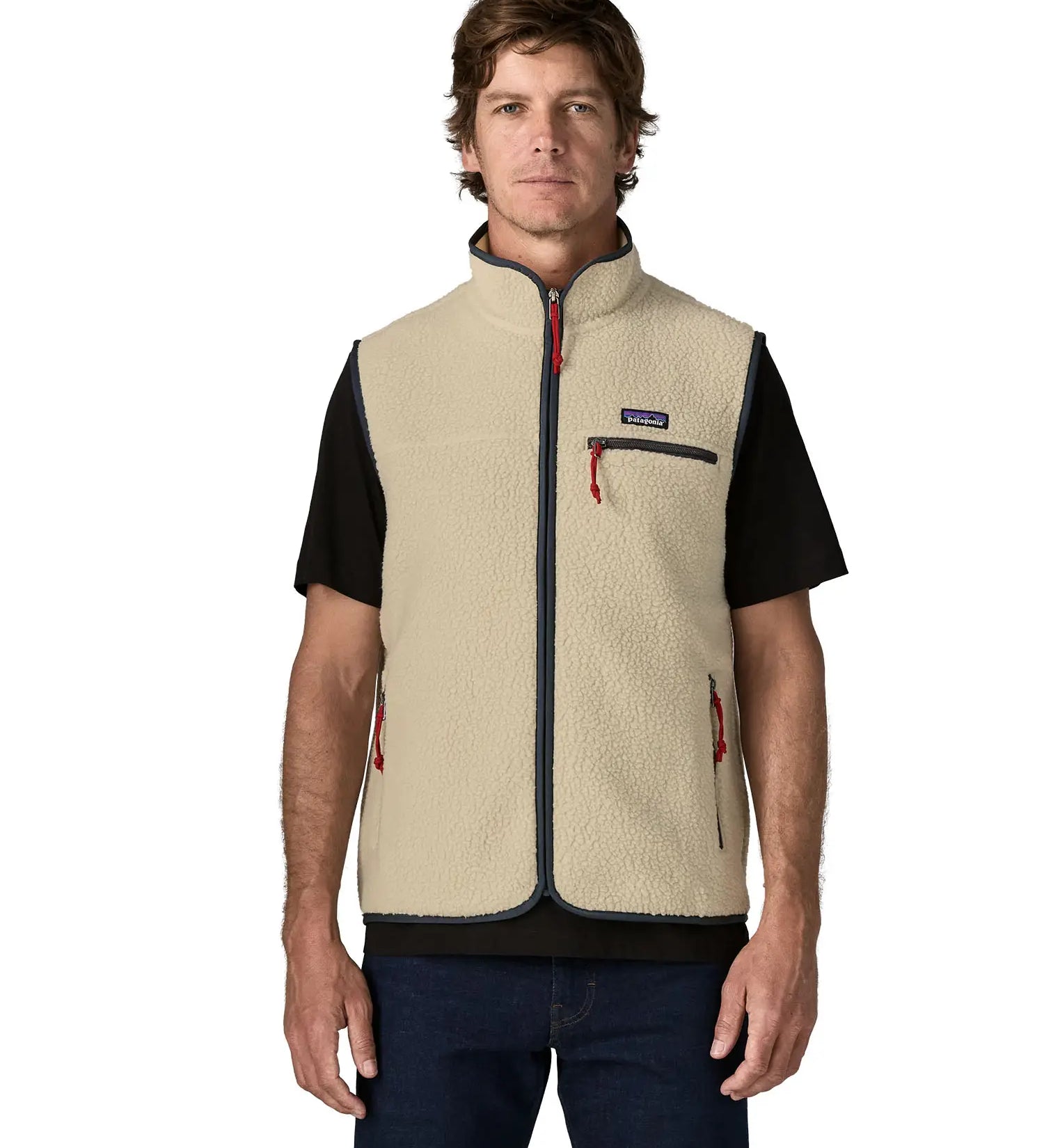 Man wearing Patagonia men's retro pile vest in beige with a navy trim. Showing front zip fastened. Gilet has a regular fit