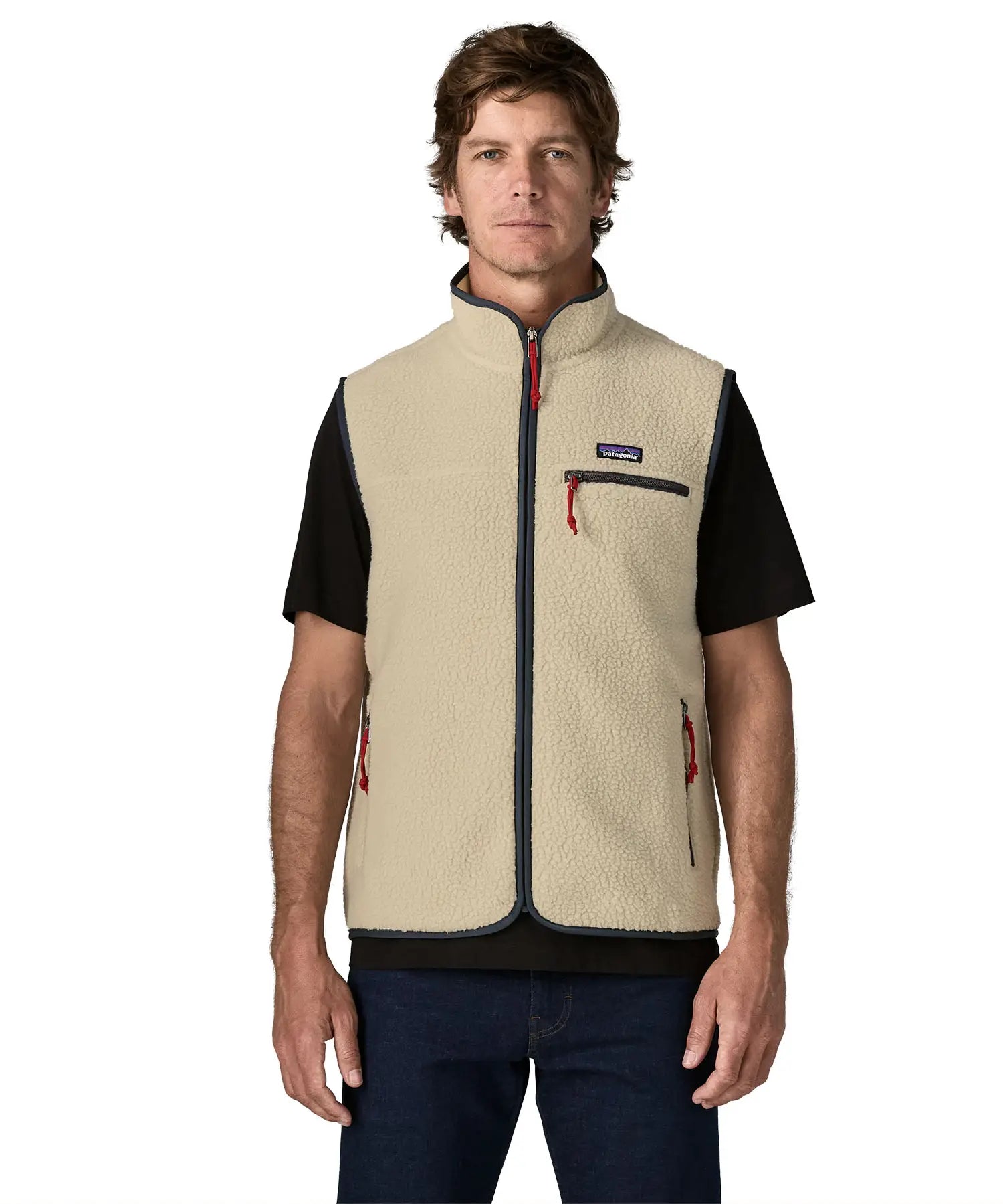 Man wearing Patagonia men's retro pile vest in beige with a navy trim. Showing front zip fastened. Gilet has a regular fit